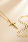 Gold crucifix flat lay - diagonal overhead