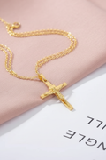 Gold crucifix flat lay - overhead angle